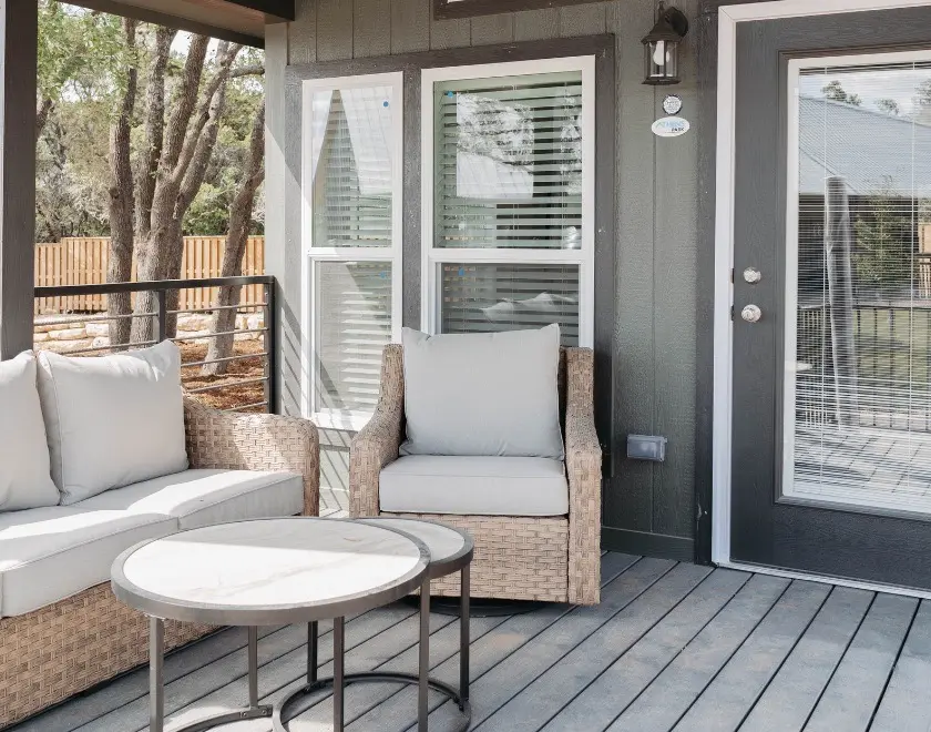 The Mingo cabin's covered porch and deck at Horseshoe Ridge RV Resort, Wimberley TX