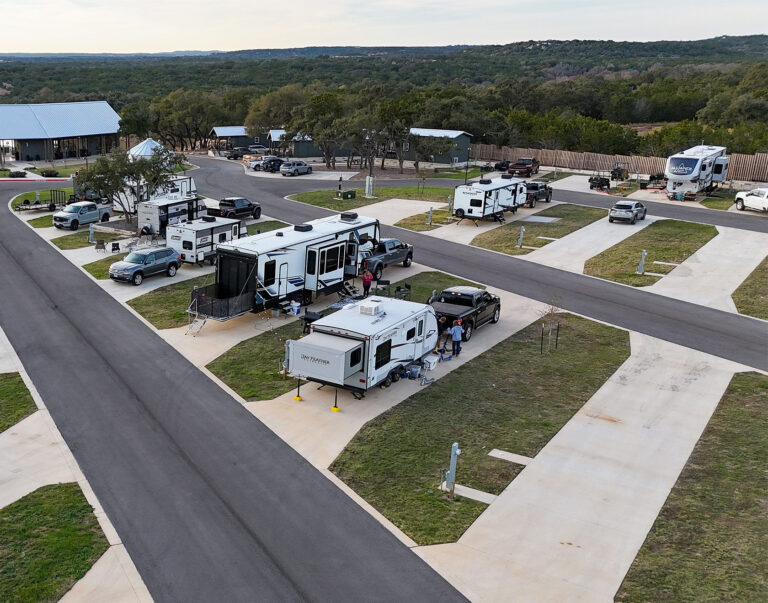 exterior view of luxury RV site amongst trees and grass