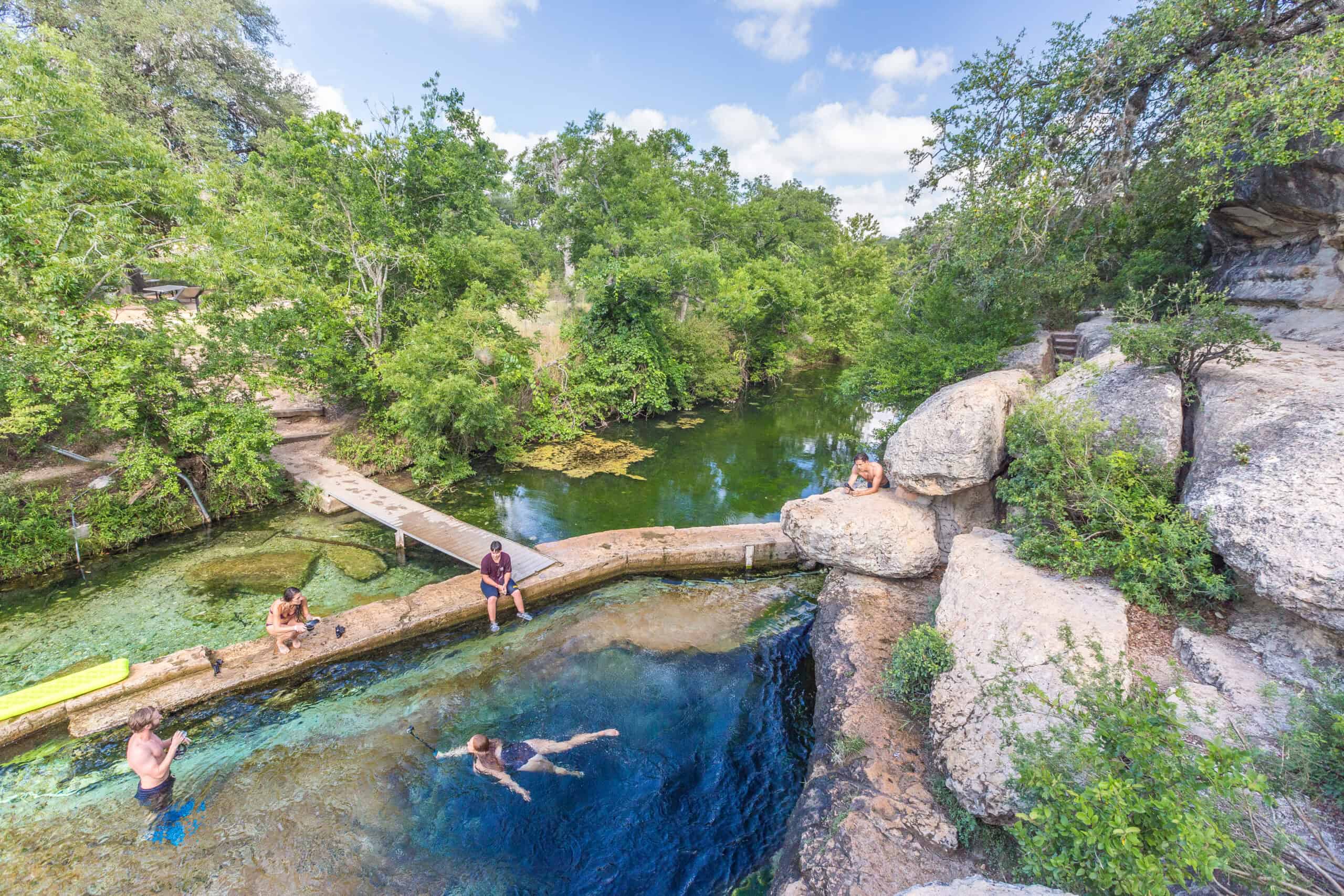 Swimmers at the springfed blue pool of Jacob's Well near Wimberley in the Texas Hill Country