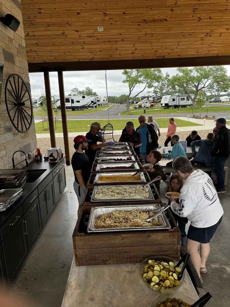 Guests gathered for a meal under the pavilion at Horseshoe Ridge RV Resort