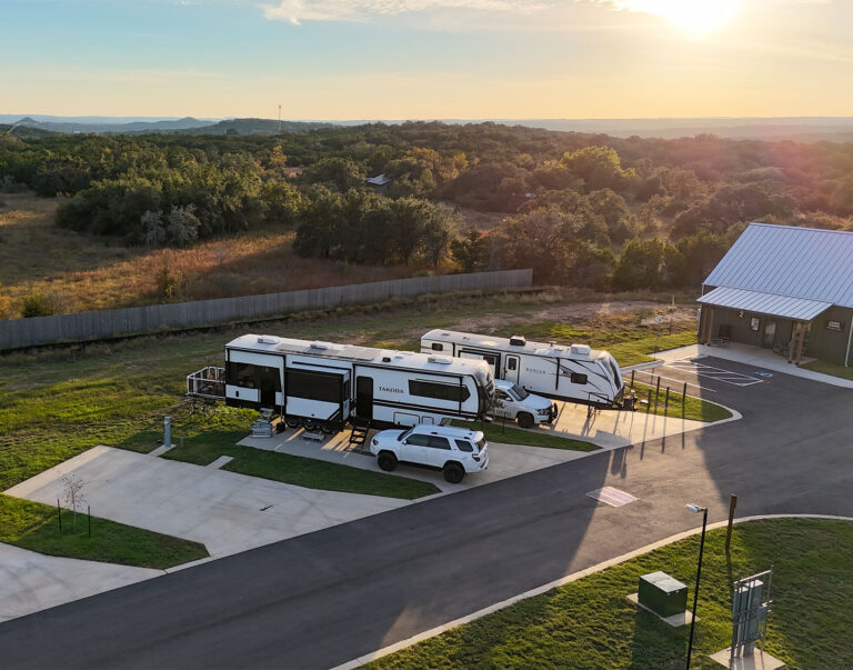 exterior view of RV site amongst trees and grass