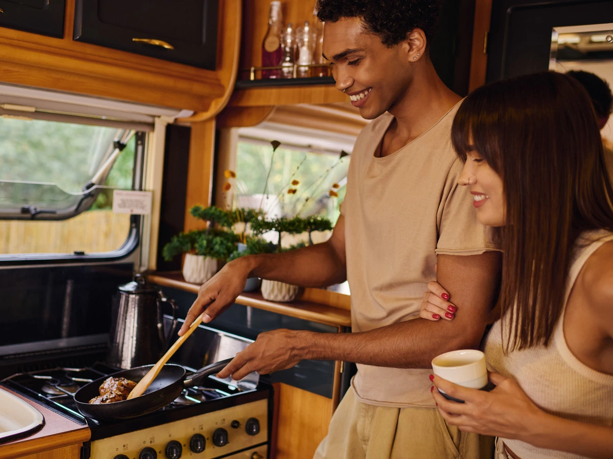 Couple cooking inside their RV — packing food for a Texas Hill Country trip