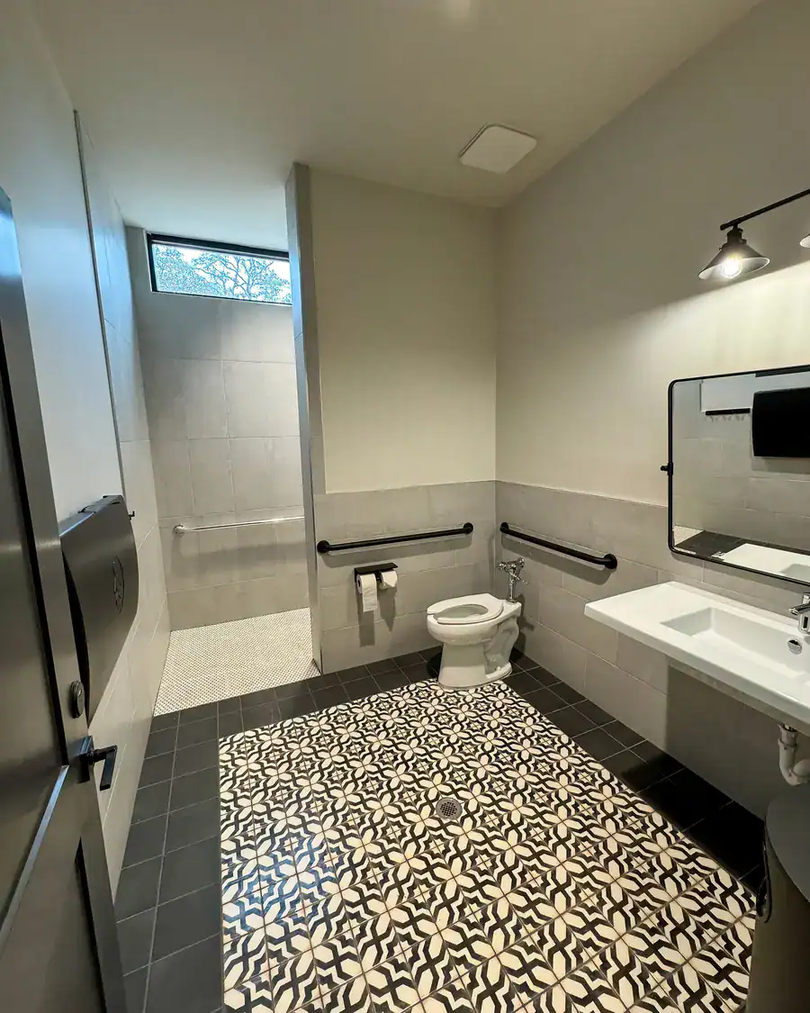 Bath house shower room with a black-and-white patterned tile floor