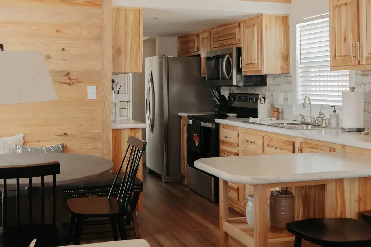 Sea Biscuit cabin's hickory kitchen and dining nook beside the knotty-pine accent wall