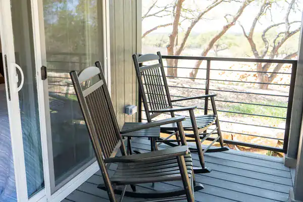 Rocking chairs on the Sea Biscuit back porch, just off the bedroom, looking into the oaks