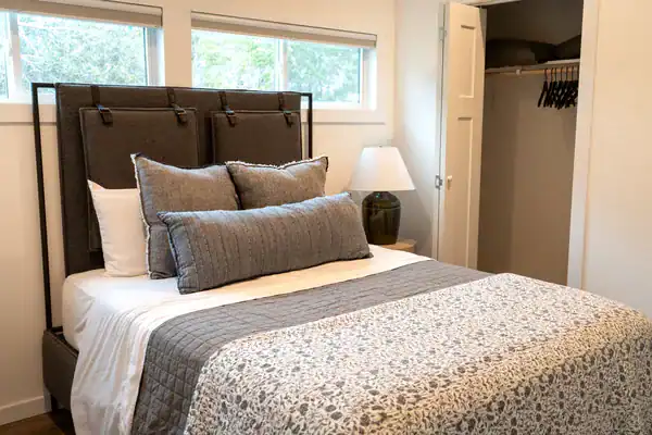 Queen bed with an upholstered headboard in Secretariat's private bedroom