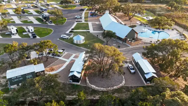 Aerial view of the three cabins beside the resort pool and pavilion at Horseshoe Ridge