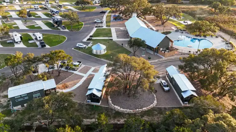 Aerial view of the three cabins beside the resort pool and pavilion at Horseshoe Ridge