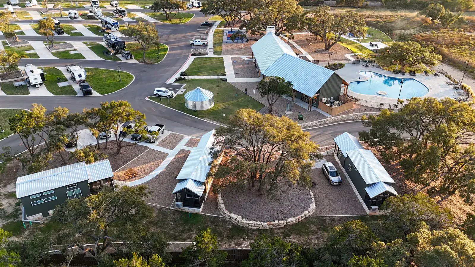Aerial view of the three cabins beside the resort pool and pavilion at Horseshoe Ridge