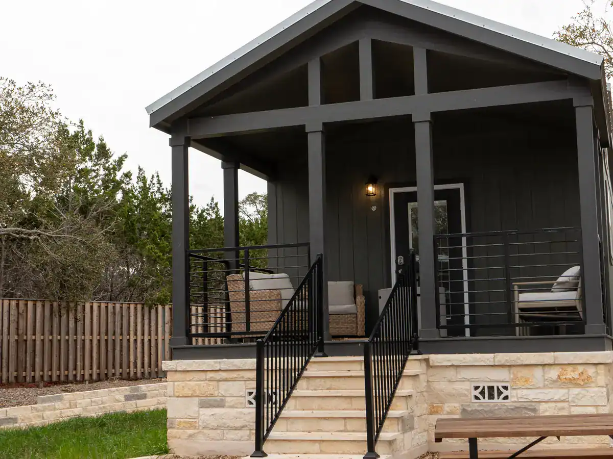 Secretariat cabin with its covered porch and picnic table among the oaks