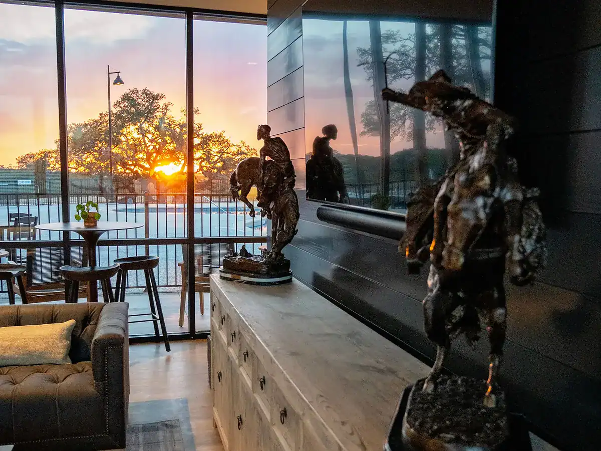 Clubhouse lounge with floor-to-ceiling windows at sunset