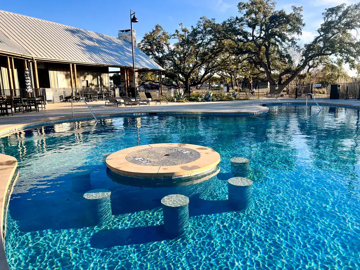 Resort pool with swim-up stools beside the Horseshoe Ridge clubhouse