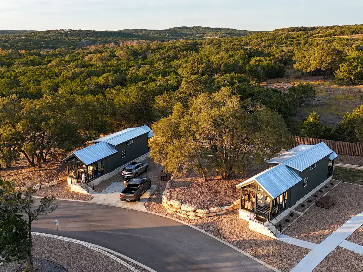 Two of the furnished cabins at Horseshoe Ridge among the oaks at sunset