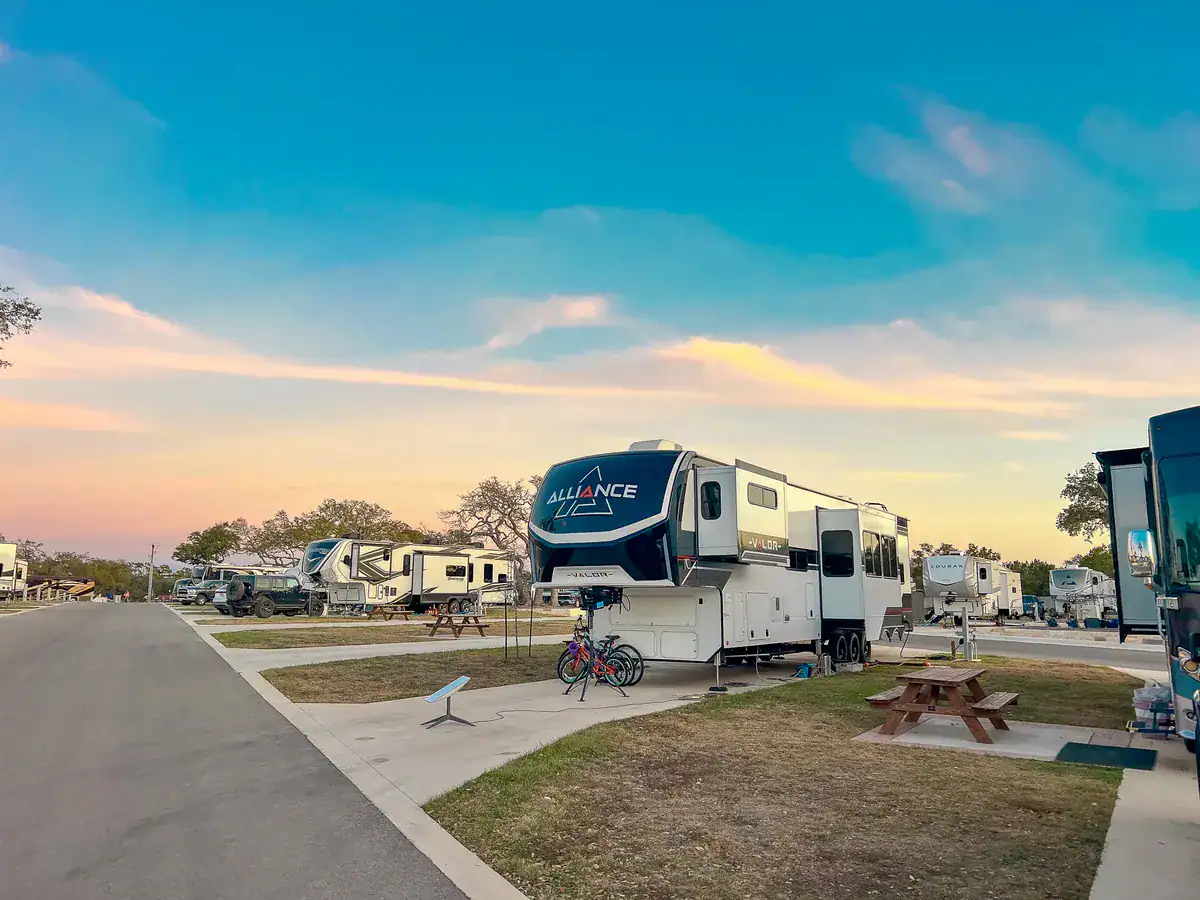 Fifth-wheel RV set up on a full-hookup site at Horseshoe Ridge at sunset