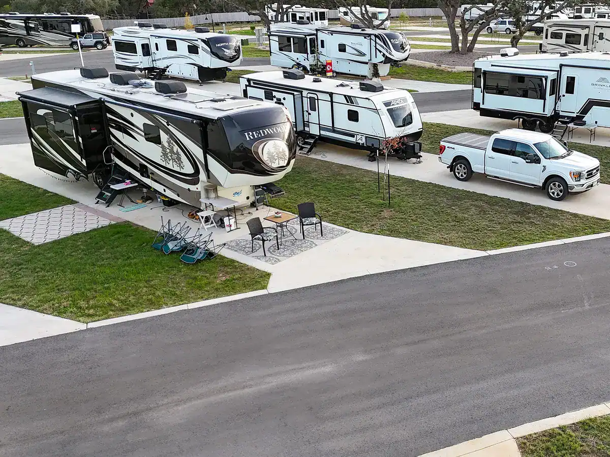 An RV site with its awning out and patio set up at Horseshoe Ridge