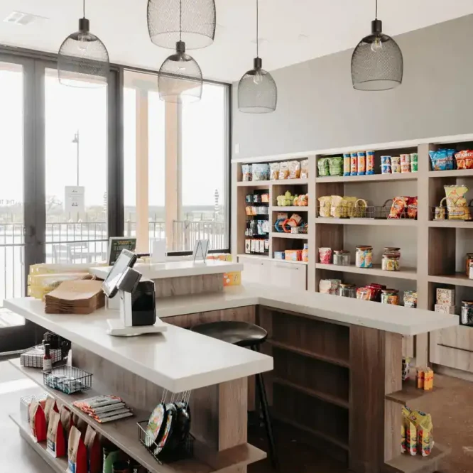 Modern convenience store interior with shelves and checkout counter.