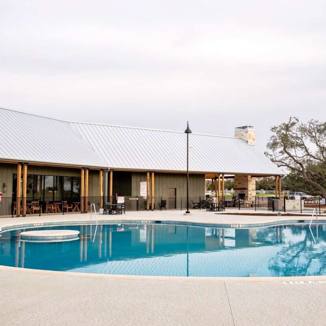 Horseshoe Ridge RV with swimming pool and clubhouse in the background.