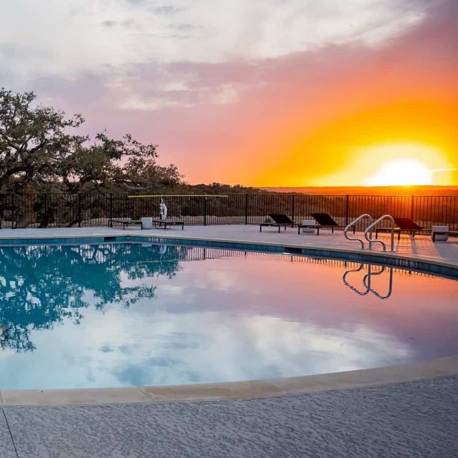 Scenic sunset view over Horseshoe Ridge RV pool area with lounge chairs.