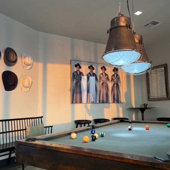 Pool table with hanging copper light fixture at Horseshoe Ridge RV.