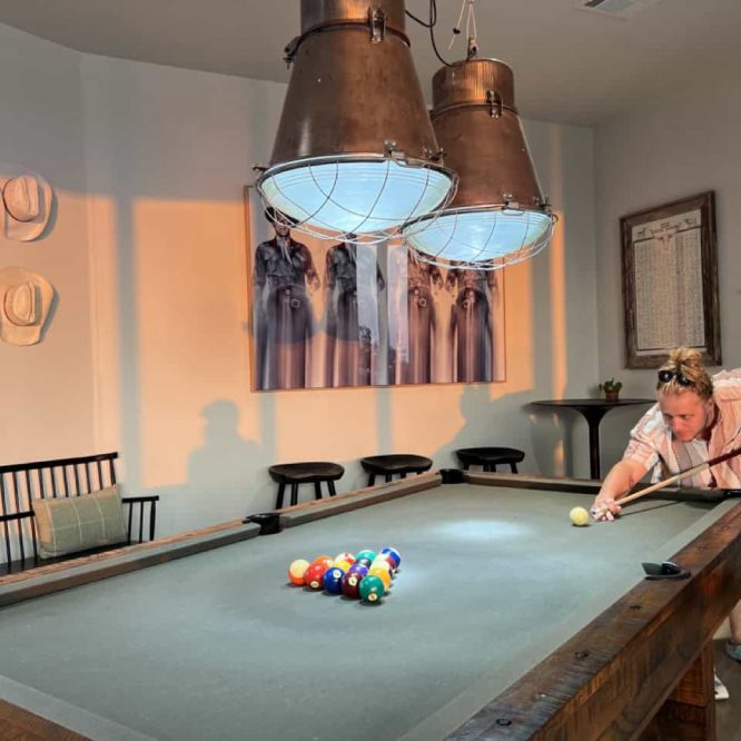Indoor billiards room at Horseshoe Ridge RV with pool table and copper pendant lights.