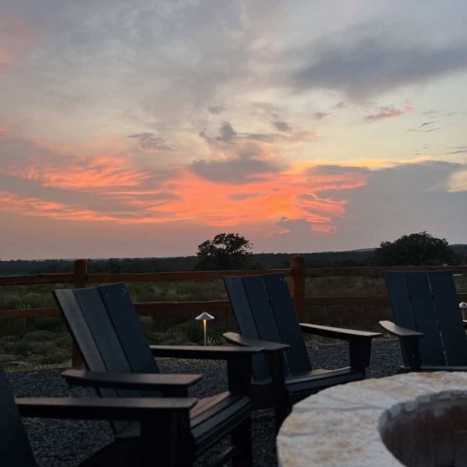 Outdoor seating area at Horseshoe Ridge RV with sunset sky in background.