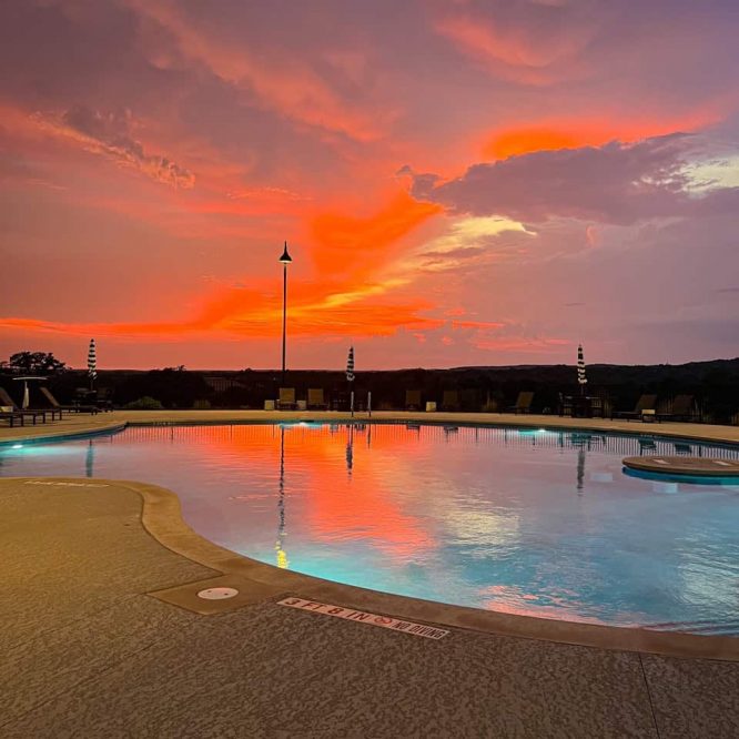 Scenic sunset over Horseshoe Ridge RV pool with vibrant sky colors.