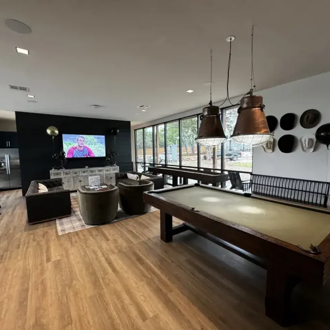 Modern game room at Horseshoe Ridge RV with pool table and TV.