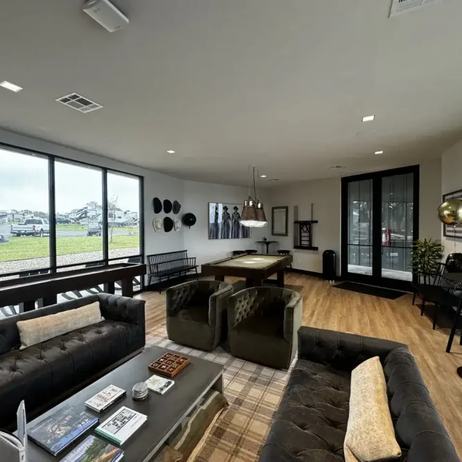 Spacious modern lounge area at Horseshoe Ridge RV with large windows and comfortable seating.